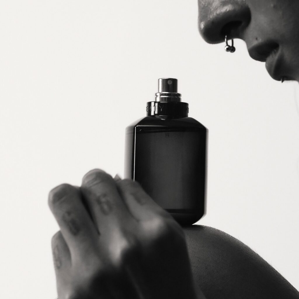person smelling fragrance fenty